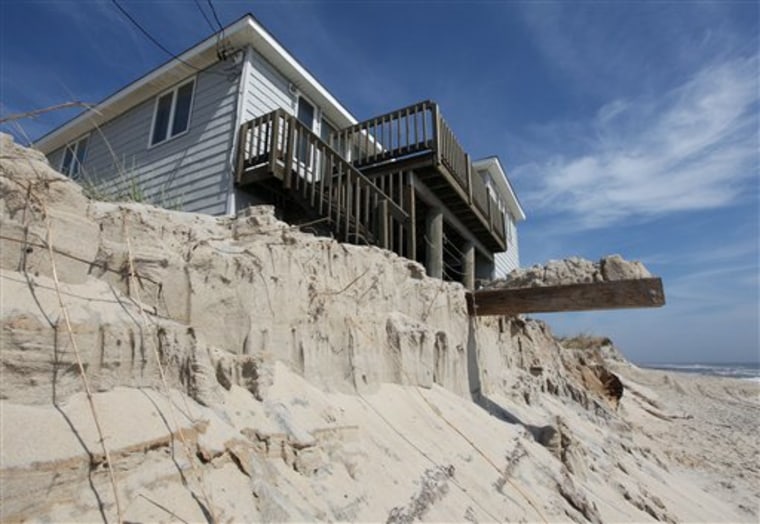 A badly eroded sand dune exposes part of the structure of an oceanfront home on Long Beach Island, N.J.